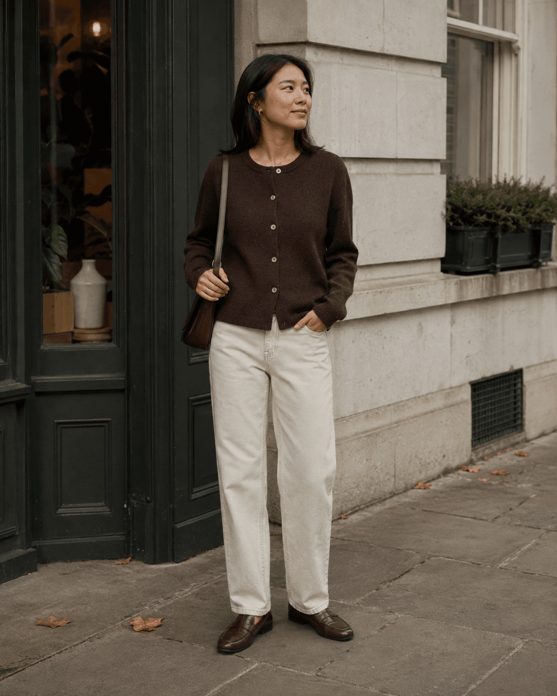 Espresso cardigan and cream trousers in warm daylight